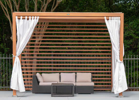 A poolside lounge area with a white canopy and a brown lattice backdrop at The Preserve at Pine Valley Apartments, Wilmington, NC 28412