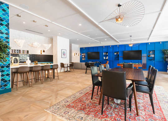 A dining room with a wooden table surrounded by chairs.at The Vale at the Parks, Washington District of Columbia  