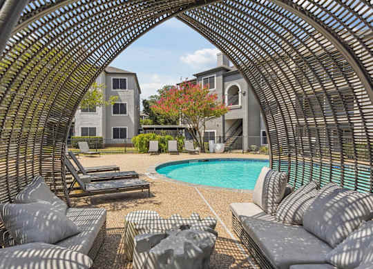 A large outdoor seating area with a pool and a building in the background.at Onyx183, Austin, TX  