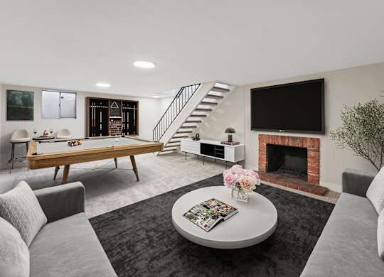 A living room with a grey couch, a coffee table, a fireplace, and a television. at The Lex At Lowry, Denver, CO