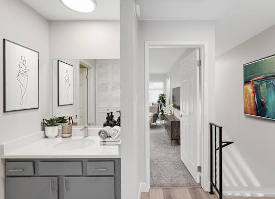 A bathroom with a white countertop and a white sink. at The Lex At Lowry, Denver