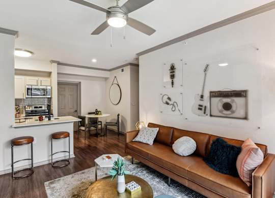 A living room with a brown leather couch and a coffee table in front of it.at Onyx183, Texas  