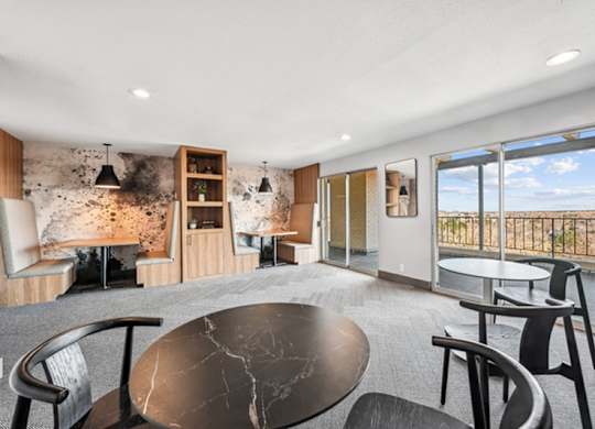 A modern living room with a black marble table and chairs. at The Lex At Lowry, Colorado