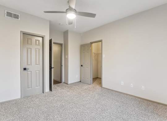 A room with a ceiling fan and three doors.at Onyx183, Texas, 78729
