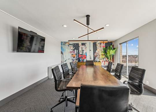 A conference room with a long table and chairs. at The Lex At Lowry, Denver, Colorado