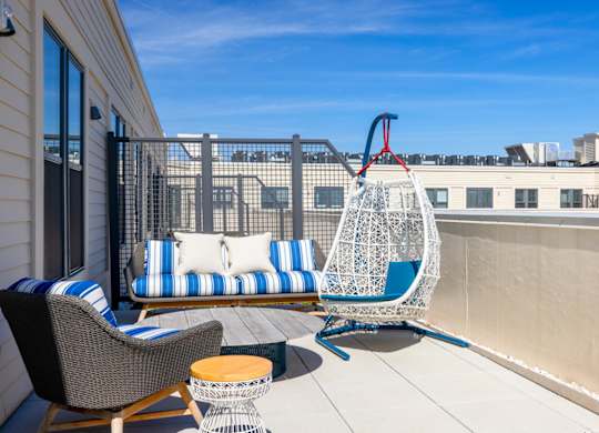 A patio with a hanging chair and a couch.at The Vale at the Parks, District of Columbia, 20012
