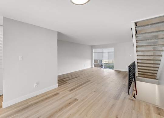 A room with wooden floors and white walls. at The Lex At Lowry, Denver