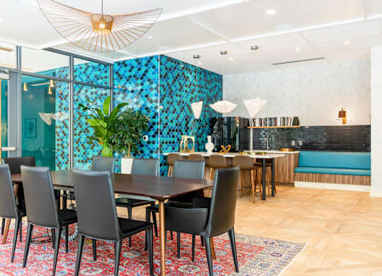A dining room with a table set for six with chairs around it.at The Vale at the Parks, Washington  