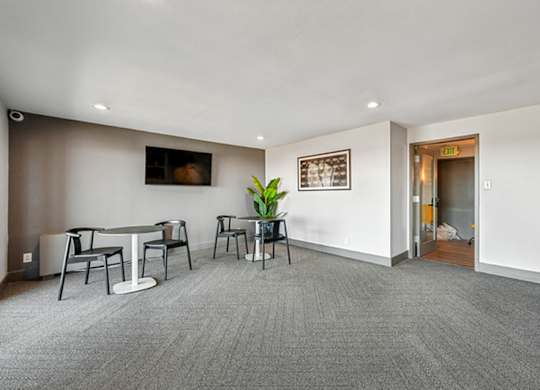 A conference room with a table and chairs and a plant. at The Lex At Lowry, Denver