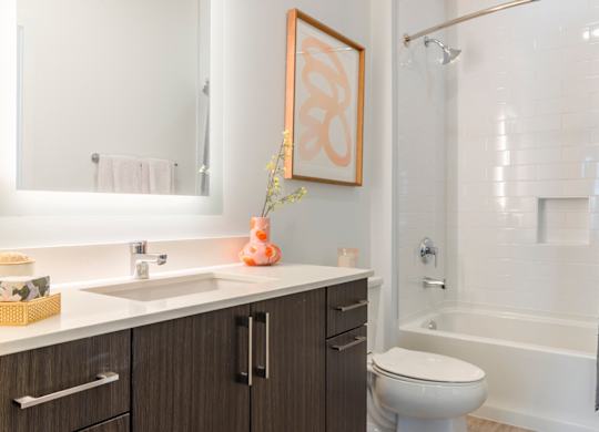 A bathroom with a white sink and a white toilet.at The Vale at the Parks, Washington  