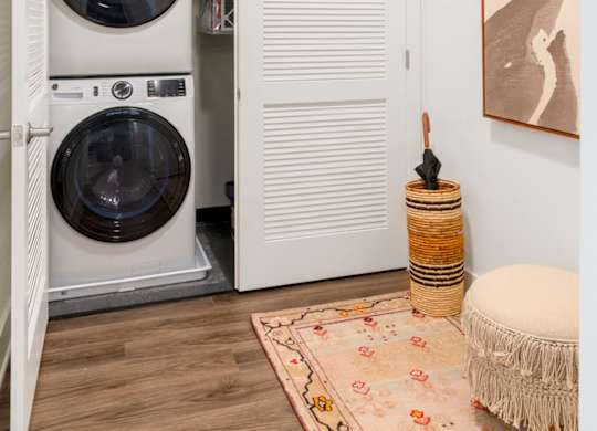 A washing machine is in a small laundry room.at The Vale at the Parks, Washington  