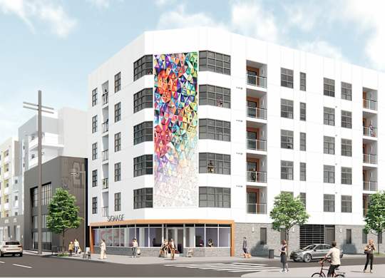 A white building with a mural on the side of it.