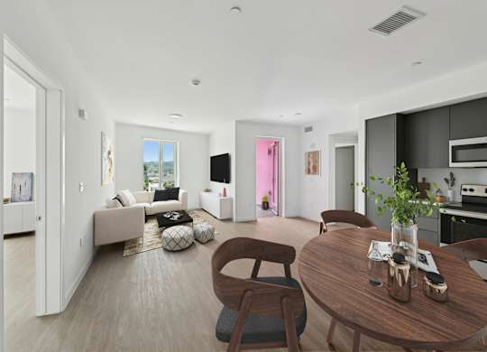 A modern living room with a brown wooden table and chairs.
