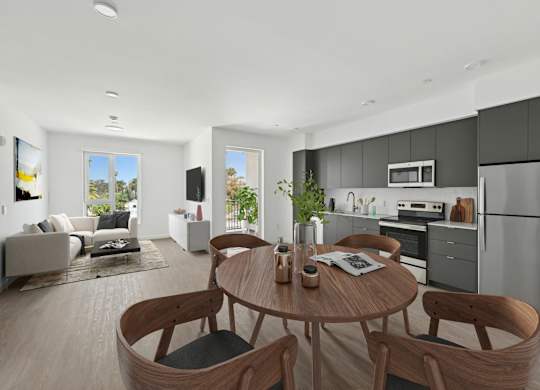 A modern kitchen with a dining table and chairs.