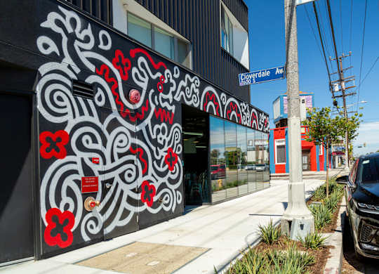 A black and red mural on the side of a building.