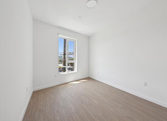 A room with a window overlooking a cityscape.
