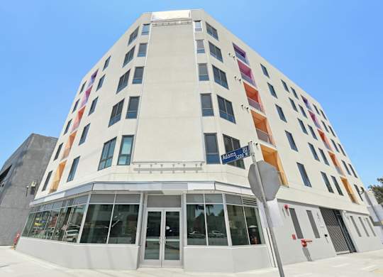 A white building with a blue sky in the background.