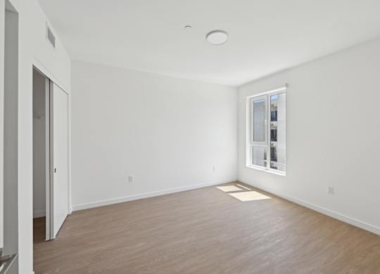 A room with a window and a door.