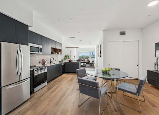 Modern kitchen with a glass table at 701 Hudson, Los Angeles