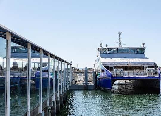 A large white boat is docked at a pier.at Channel House, Oakland, CA