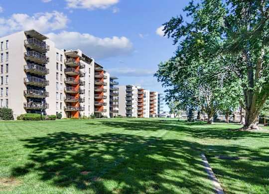 A grassy area in front of apartment buildings. at The Lex At Lowry, Denver