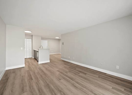 A room with wooden flooring and white walls. at The Lex At Lowry, Denver