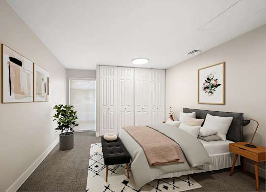 A bedroom with a large bed and a potted plant. at The Lex At Lowry, Colorado