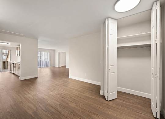 A large, empty room with wooden floors and white walls. at The Lex At Lowry, Denver, Colorado
