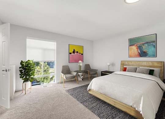 A bedroom with a large bed and a painting on the wall. at The Lex At Lowry, Denver, Colorado