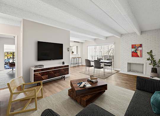 A living room with a fireplace and a television. at The Lex At Lowry, Denver, CO, 80224