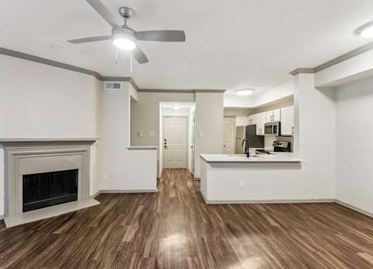 A living room with a fireplace and a ceiling fan.at Onyx183, Austin, TX 78729  