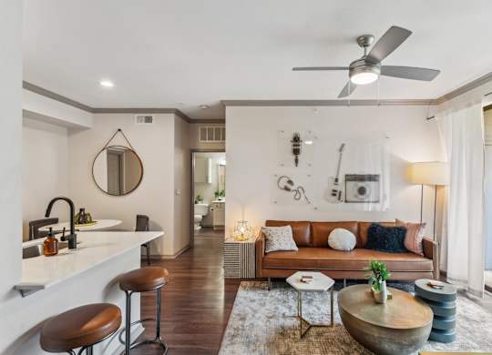 A modern living room with a brown leather couch and a wooden coffee table.at Onyx183, Texas  