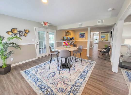 A dining room with a table and chairs.