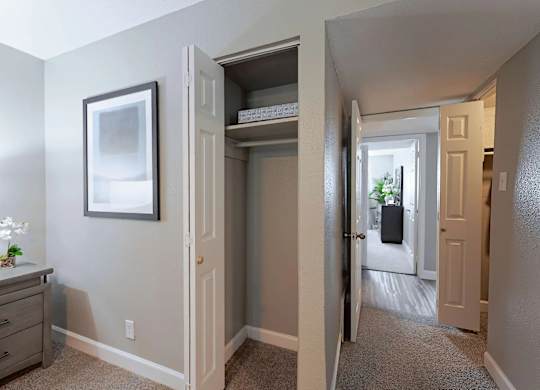 A hallway with a white door and a grey wall.