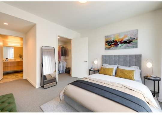 A bedroom with a large bed and a painting on the wall.at Prizma, Los Angeles, CA 90038  