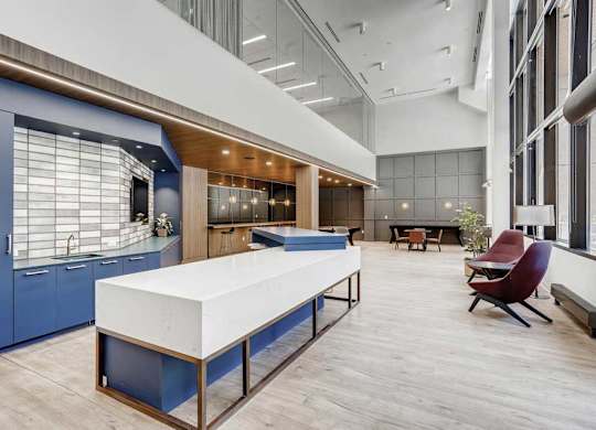 A modern kitchen with a blue cabinet and a white countertop.