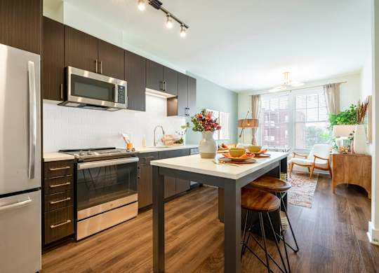 A modern kitchen with a dining table and chairs.at The Vale at the Parks, Washington, 20012  