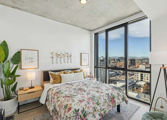 Bedroom with a large bed at Velaris Living Apartments, Denver, Colorado