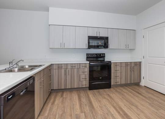 A kitchen with wooden floors and white walls.
