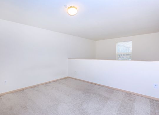 A room with a light on the ceiling and a window on the wall.