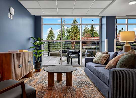 A living room with a blue couch and a wooden coffee table.