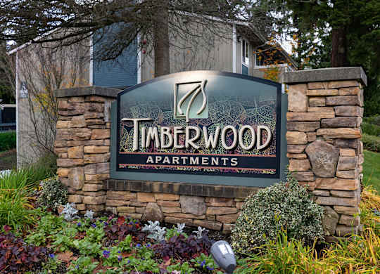 Timberwood Apartments sign in front of a building.