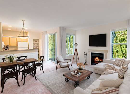 A living room with a fireplace and a flat screen TV mounted on the wall.