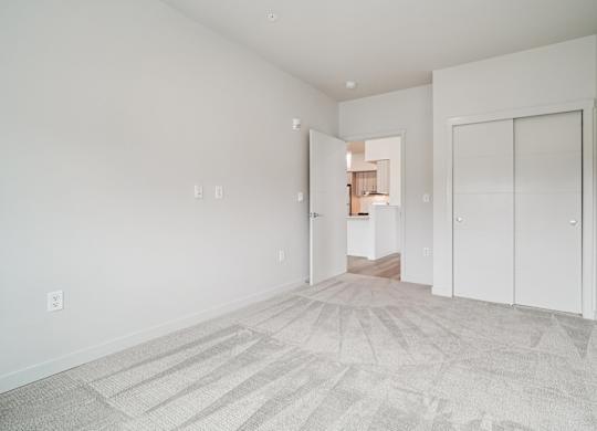 A room with a carpeted floor and white walls.
