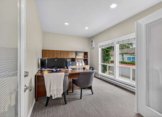 A home office with a desk, chair, and computer.