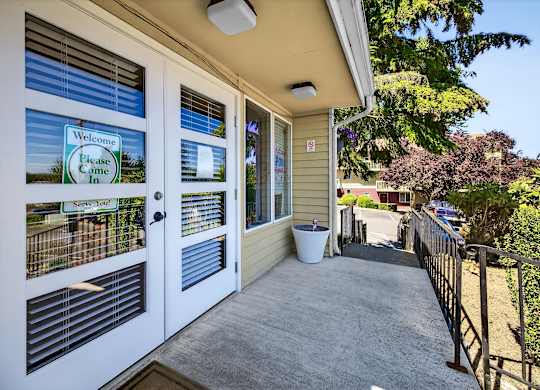A house entrance with a sign that says "Welcome, Please Come In".