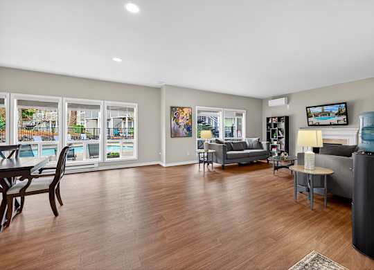 A living room with a couch, chair, and television.
