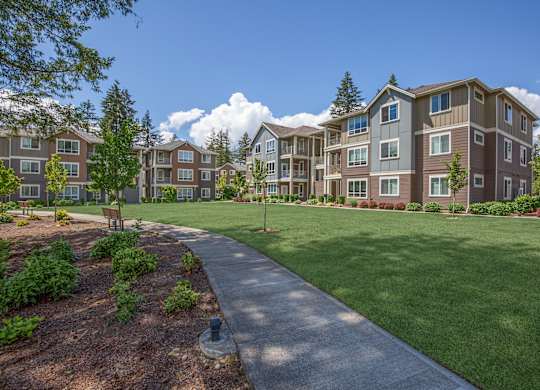Apartment complex with a walkway in the foreground.