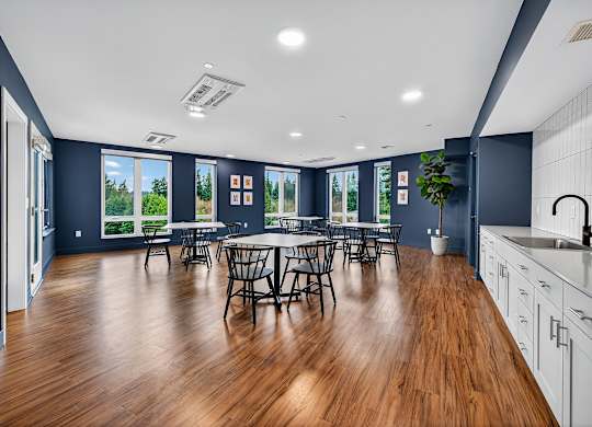 A modern kitchen with a dining table and chairs.