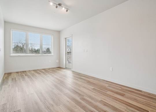 A room with a window and a door.
